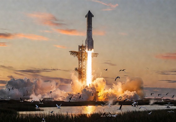 Photorealistic wide-angle view of SpaceX Starship and Super Heavy booster launching from Starbase Texas at dawn, massive plume of fire and steam illuminating the surrounding marshland, golden light catching the stainless steel surface of the rocket, birds scattering from the wetlands in the foreground, dramatic and awe-inspiring composition emphasizing scale and technological power